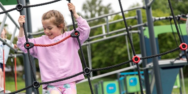 Child climbing in the playground at Staunton Harold