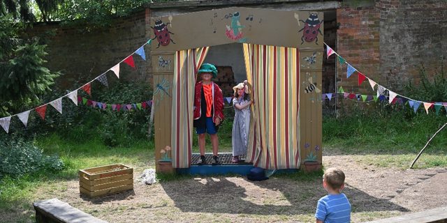 Children putting on a performance in The Garden of Imagination at Calke Abbey